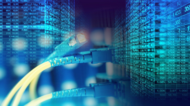 Fiber optic cables glowing with blue light, set against a blurred background of server racks in a data center.